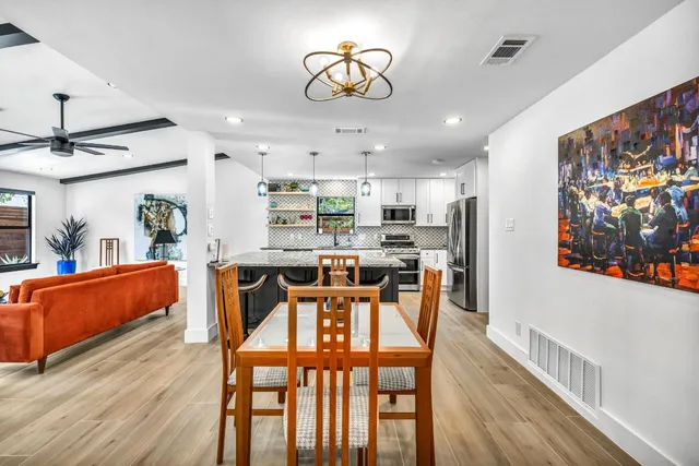 a view of a dining room with furniture and wooden floor