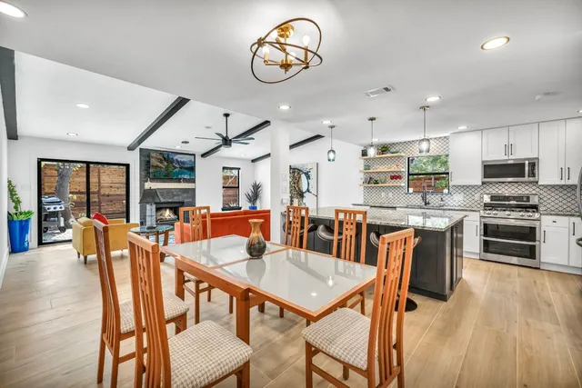 a view of a dining room with furniture kitchen and wooden floor