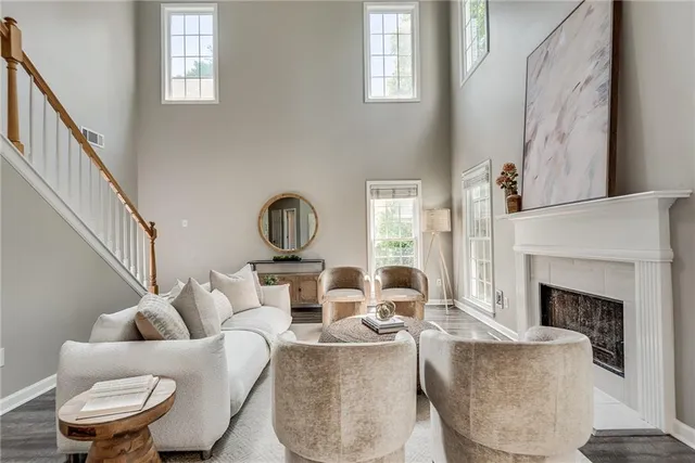 a living room with furniture a fireplace and a window