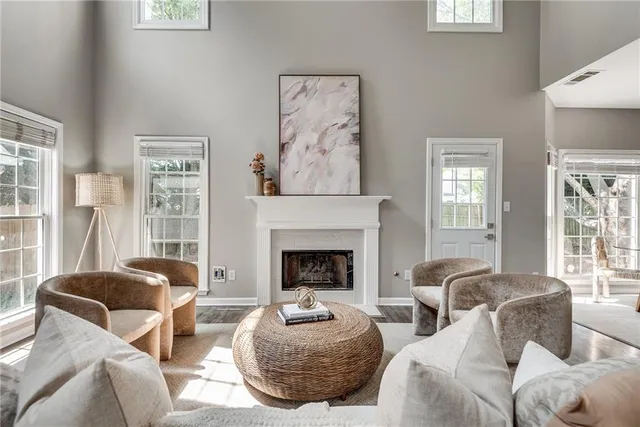a living room with furniture a fireplace and windows