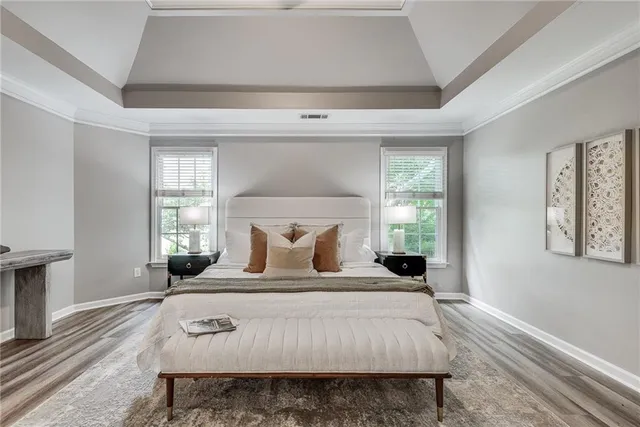 a bedroom with a bed and wooden floor