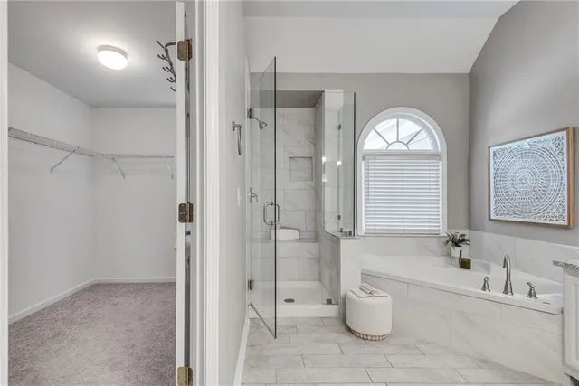 a spacious bathroom with a granite countertop toilet sink and shower