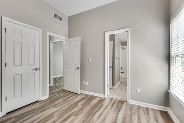 a view of a room with wooden floor and windows