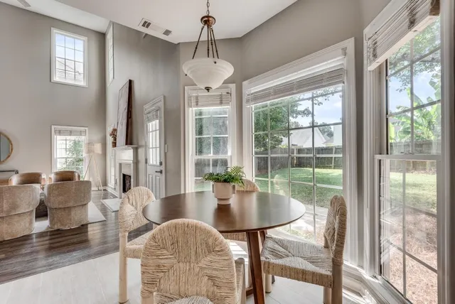 a living room with fireplace furniture and a chandelier