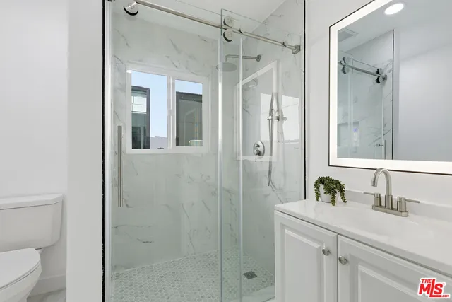 a view of a chair and table in backyard of the house