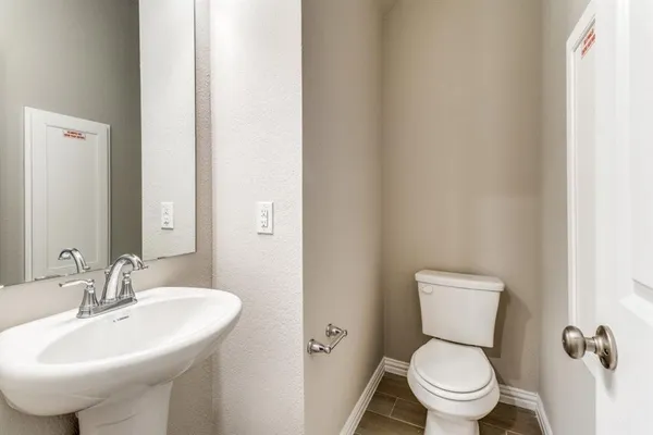 a bathroom with a sink toilet and a mirror
