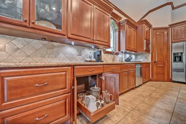 a view of a porch with chairs and backyard of the house