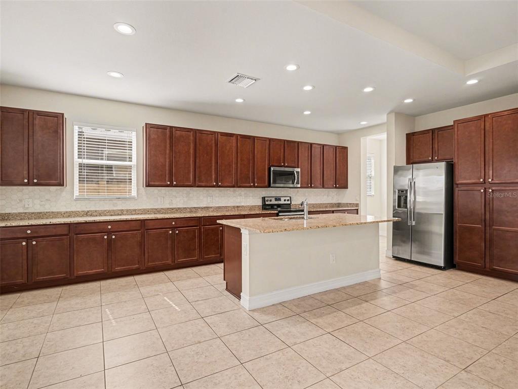4429 Conchfish Lane Osprey, FL 34229 - Photo 4 of 20 a kitchen with stainless steel appliances granite countertop a refrigerator sink and cabinets