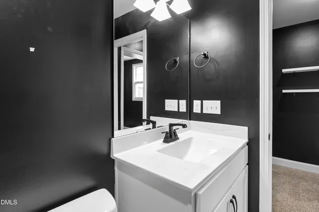 a kitchen with stainless steel appliances granite countertop a sink stove refrigerator and cabinets