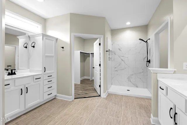 a kitchen with stainless steel appliances granite countertop white cabinets stove a sink and dishwasher