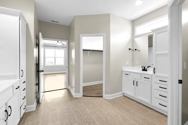 a view of empty room with wooden floor and fireplace