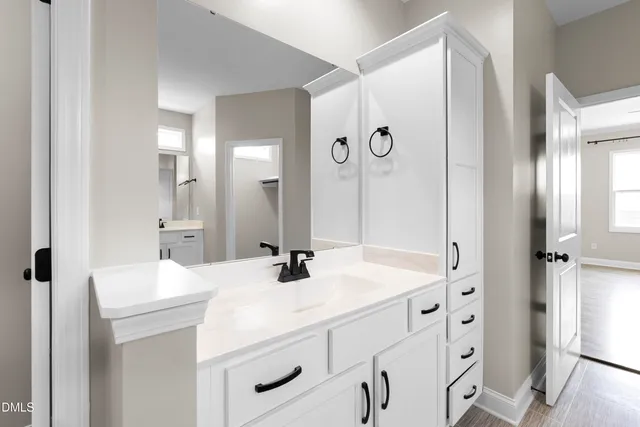 a view of a dry yard with trees in the background