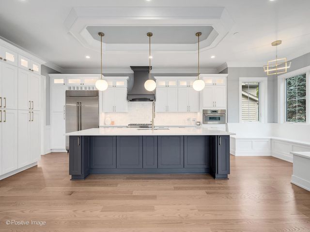 a kitchen with a refrigerator and wooden cabinets
