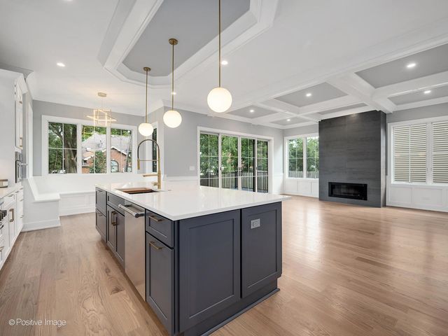 a kitchen with a stove and wooden floor