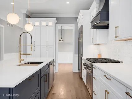 a kitchen with stainless steel appliances granite countertop a sink and cabinets