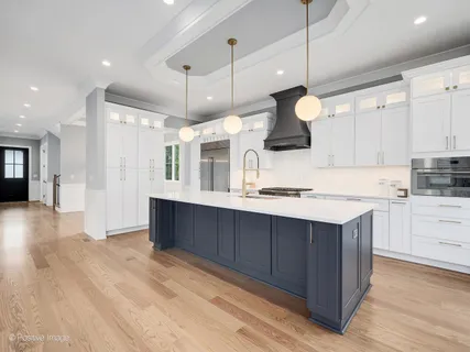 a kitchen with stainless steel appliances granite countertop a sink a stove and a refrigerator