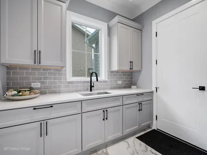 a kitchen with a sink and cabinets