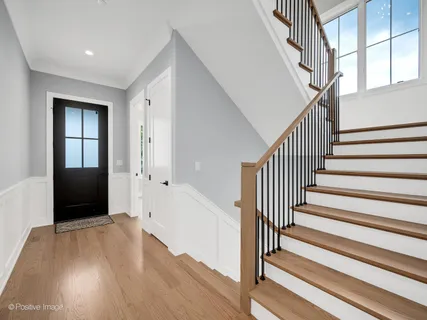 a view of entryway with wooden floor and stairs