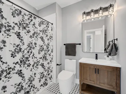 a bathroom with a sink toilet and shower