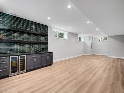 a kitchen with stainless steel appliances wooden cabinets a stove and a sink