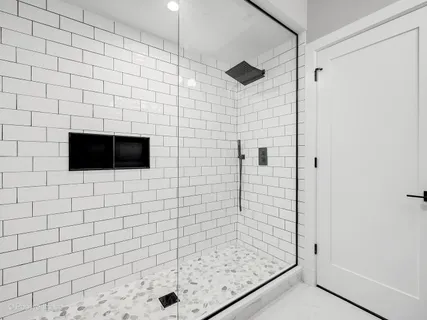 a bathroom with a shower and a sink