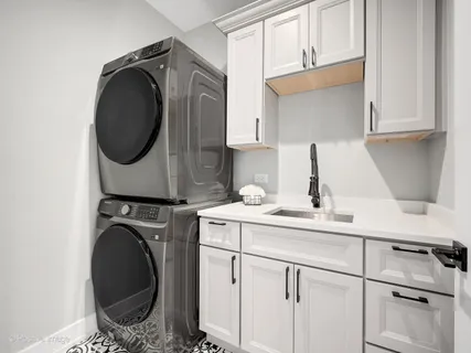 a utility room with sink dryer and washer