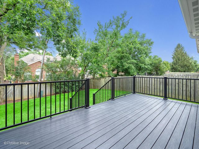 a view of a deck with wooden floor and fence