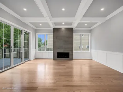 a view of a livingroom with a fireplace wooden floor and staircase