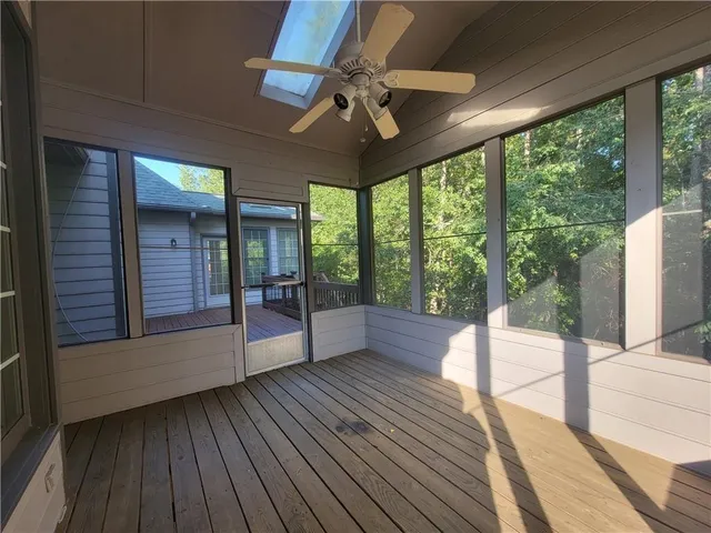 a view of a porch with wooden floor and iron stairs