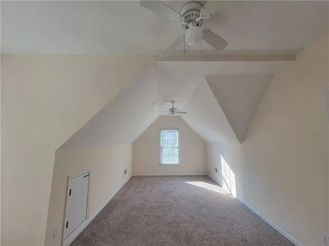 a view of a hallway with windows and chandelier fan