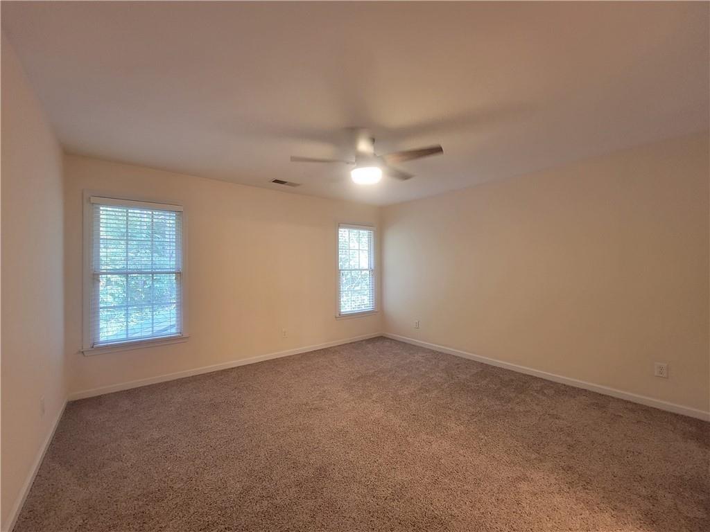 6330 Olde Atlanta Parkway Suwanee, GA 30024 - Photo 24 of 31 an empty room with windows and chandelier fan