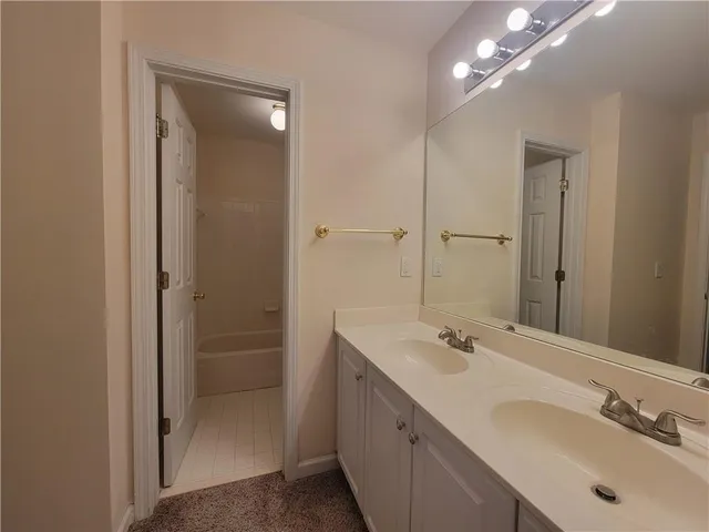 a bathroom with a double vanity sink and a mirror