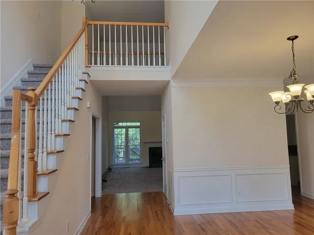 a view of a hallway with wooden floor and staircase