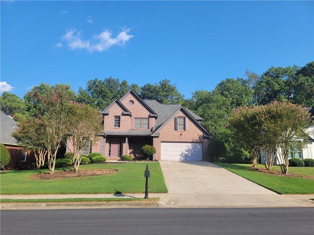 6330 Olde Atlanta Parkway Suwanee, GA 30024 - Photo 31 of 31 a front view of house with yard and green space