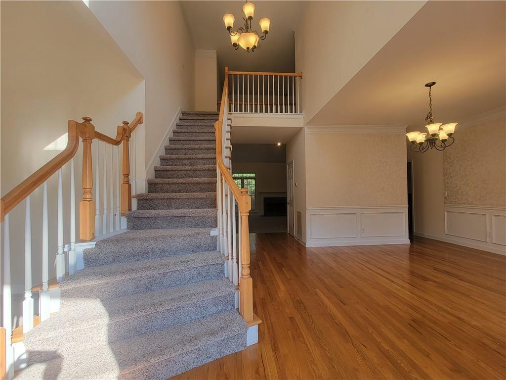 6330 Olde Atlanta Parkway Suwanee, GA 30024 - Photo 4 of 31 a view of a hallway with wooden floor and staircase