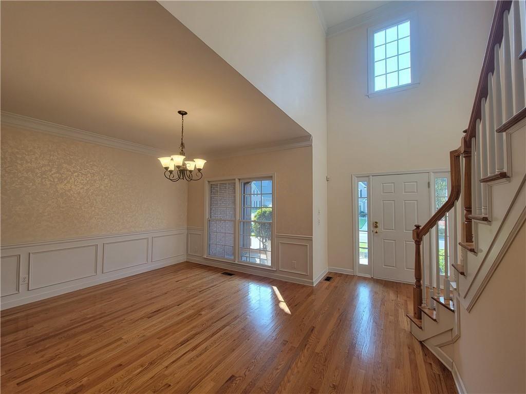 6330 Olde Atlanta Parkway Suwanee, GA 30024 - Photo 5 of 31 wooden floor in an empty room with a window