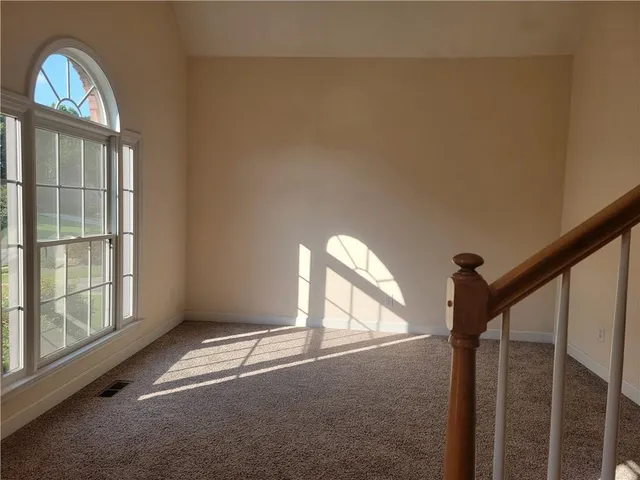 a view of empty room with stairs