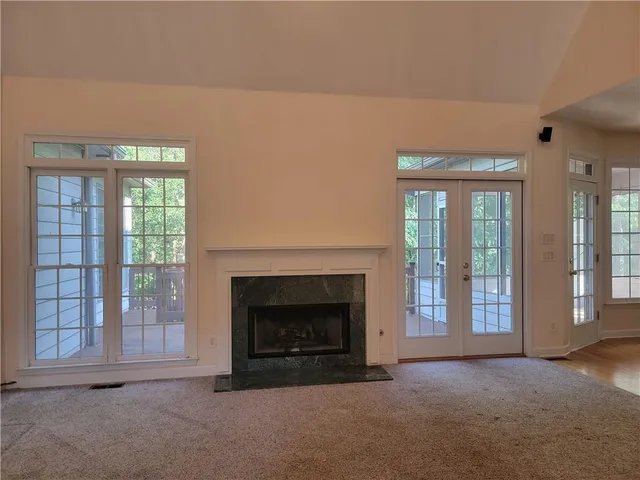 a view of empty room with a fireplace