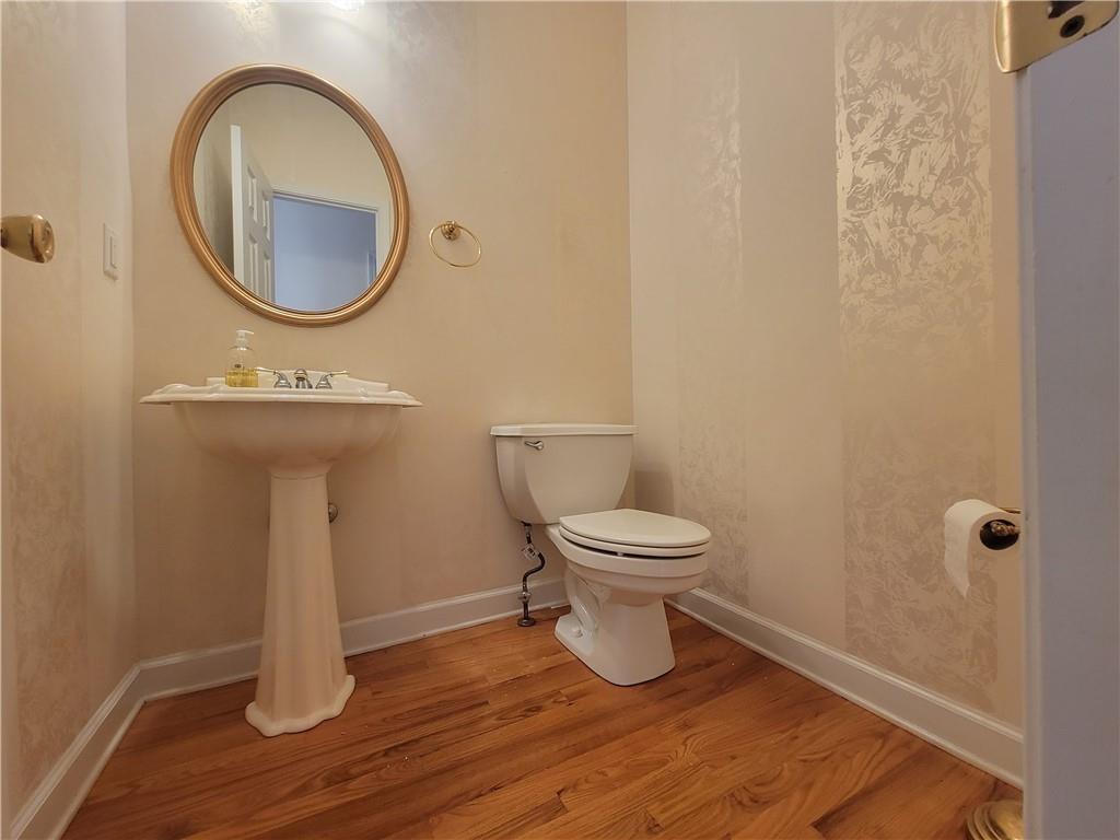 6330 Olde Atlanta Parkway Suwanee, GA 30024 - Photo 9 of 31 a bathroom with a toilet and a mirror