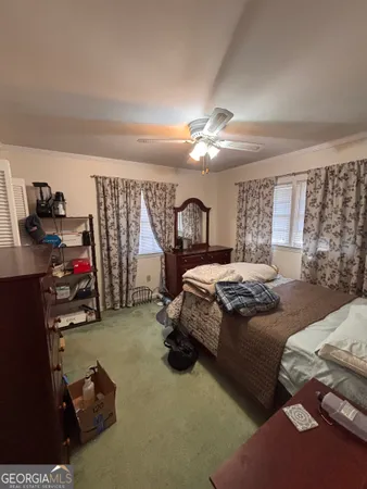 a bedroom with a bed gym equipment and a large mirror
