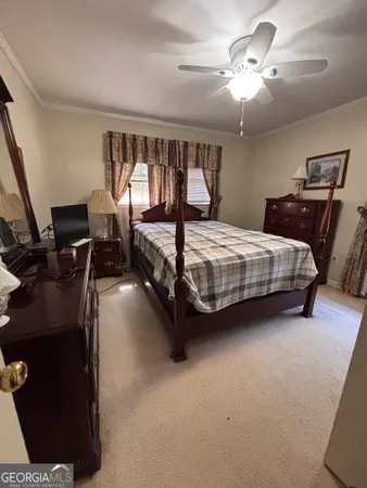 a bedroom with bed and window