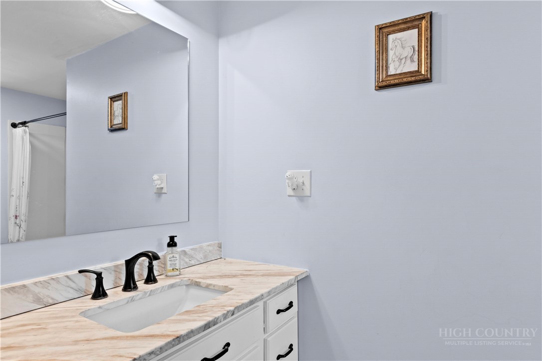 142 Pioneer Road Harmony, NC 28634 - Photo 39 of 49 a bathroom with a sink and a mirror