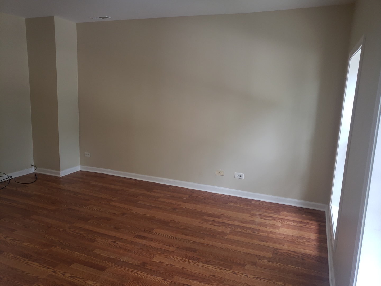 322 North County Street, Unit FRONT Waukegan, IL 60085 - Photo 13 of 15 a view of an empty room with wooden floor