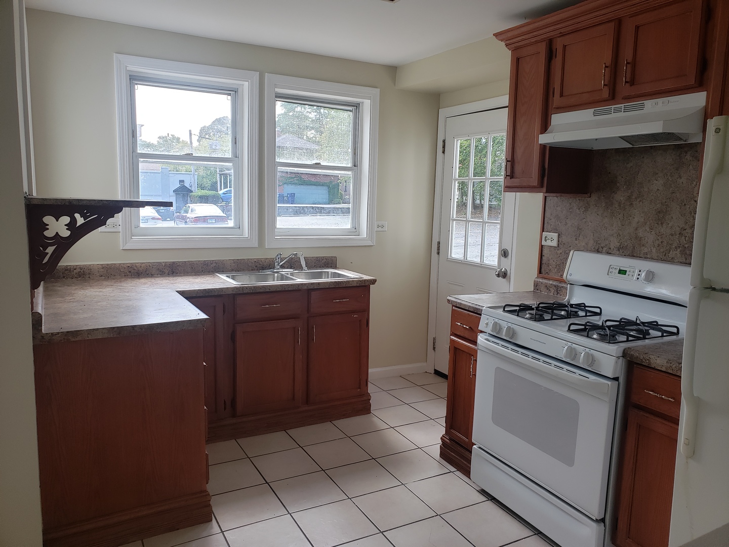 322 North County Street, Unit FRONT Waukegan, IL 60085 - Photo 3 of 15 a kitchen with a stove sink and cabinets