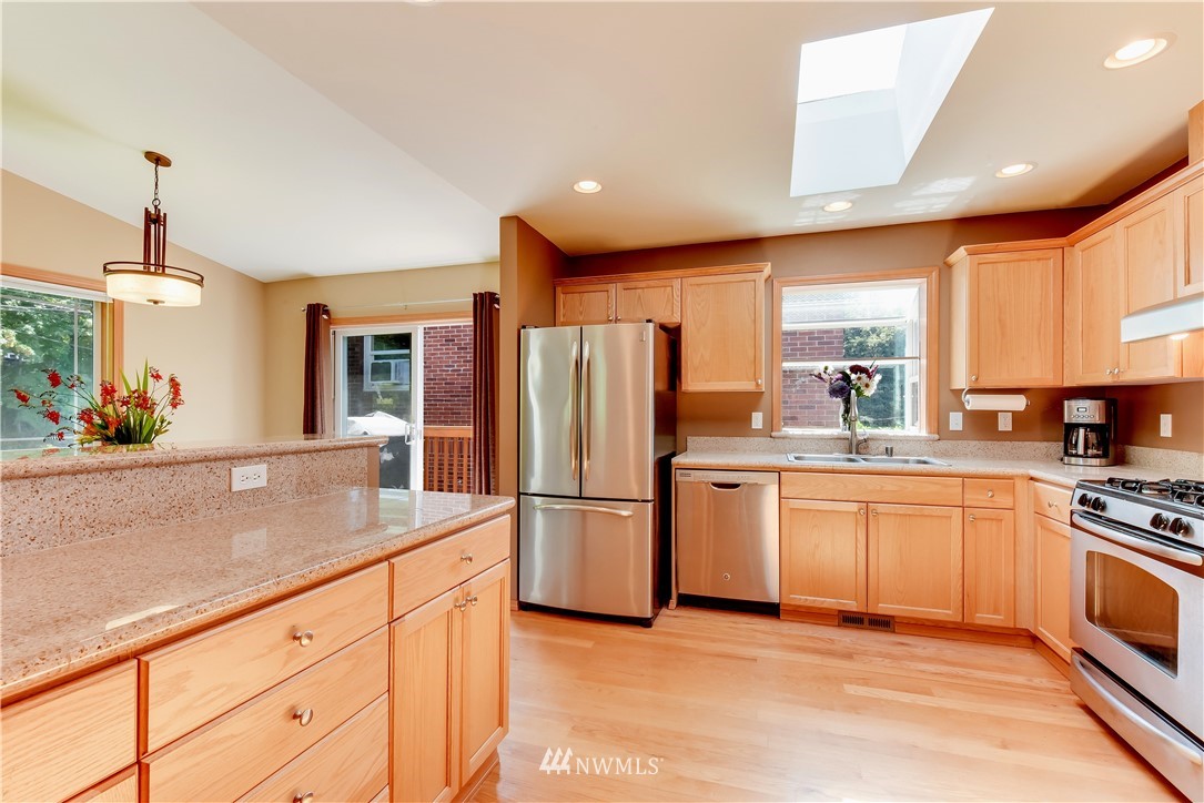 5317 Renton Avenue South Seattle, WA 98118 - Photo 8 of 20 a kitchen with stainless steel appliances granite countertop a refrigerator a stove and a sink