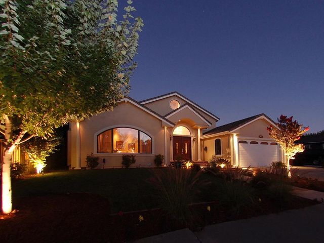 a front view of a house with a garden