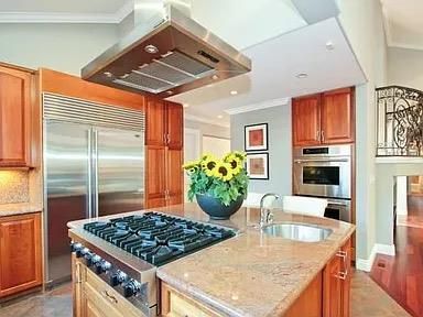 a kitchen with a stove a sink and a refrigerator