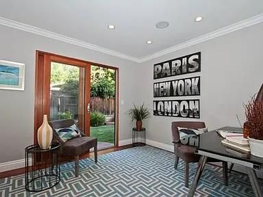 a living room with furniture and a floor to ceiling window