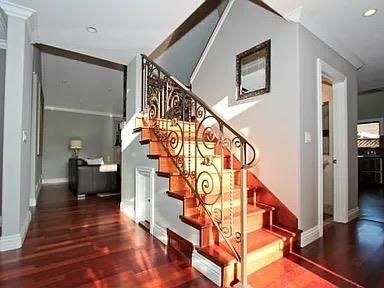 a view of entryway and hall with wooden floor