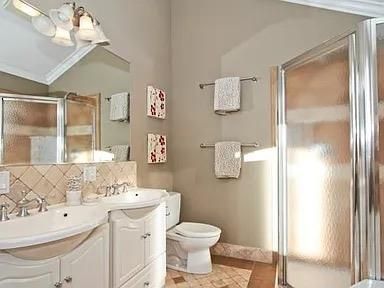 a bathroom with a sink toilet vanity and shower
